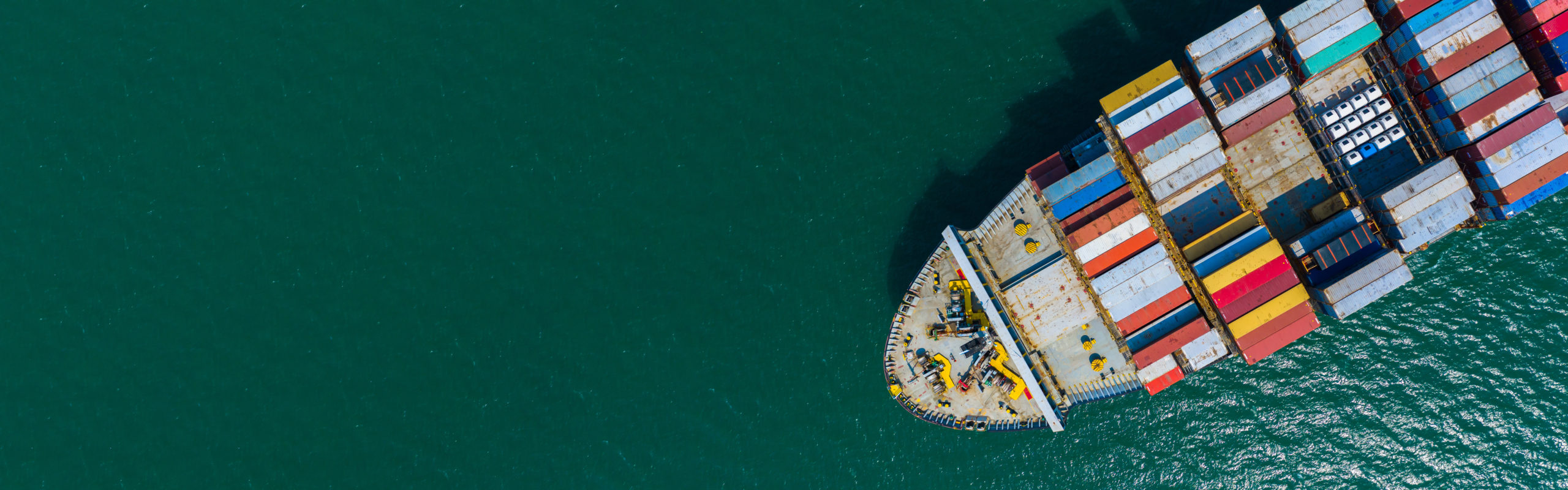 Container cargo ship carrying container for import and export, business logistic and transportation by container ship boat in open sea, Aerial view container ship with copy space for design banner web